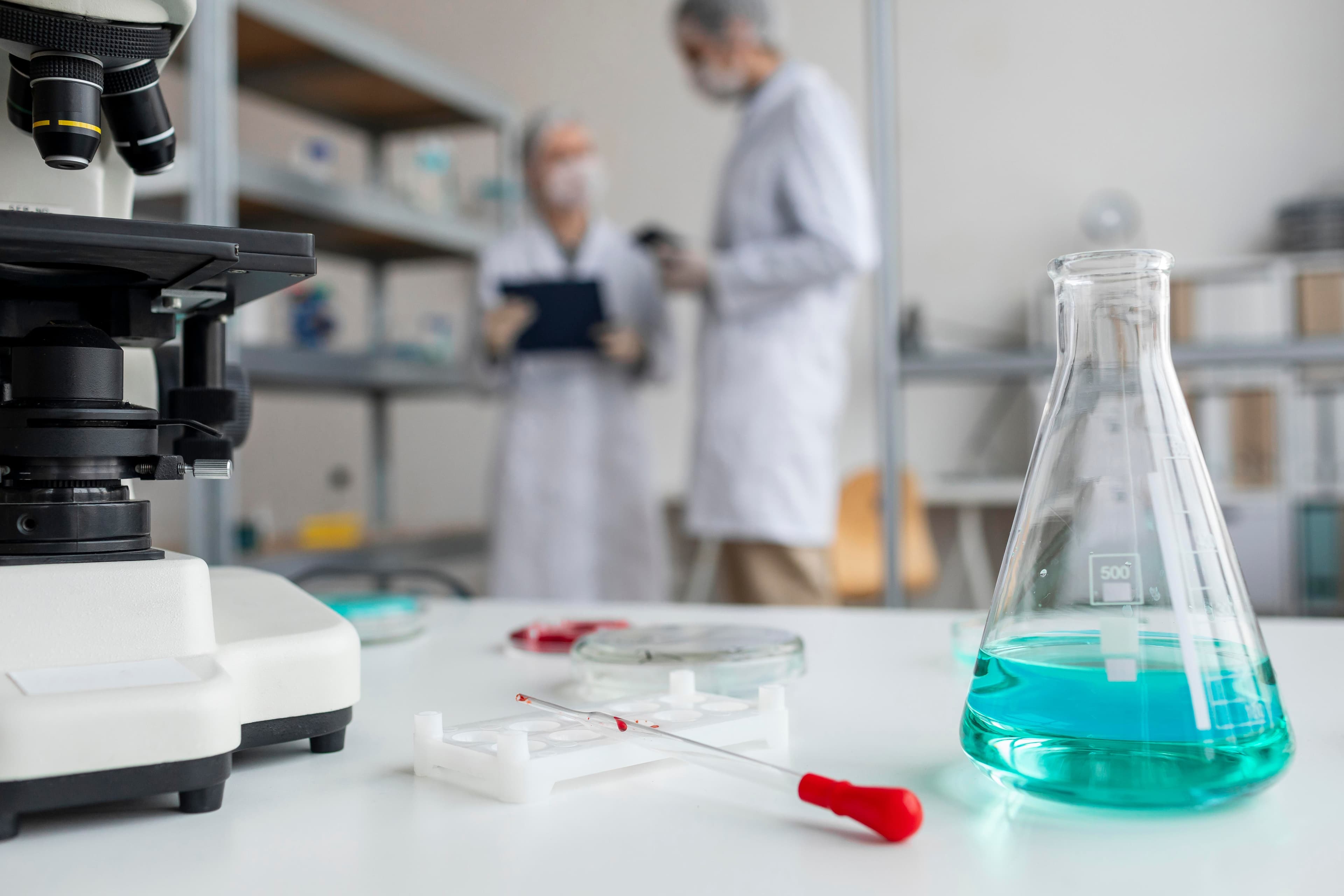 A modern pharmaceutical laboratory with lab equipment, glassware, and researchers conducting experiments. A modern pharmaceutical laboratory with lab equipment, glassware, and researchers conducting experiments.